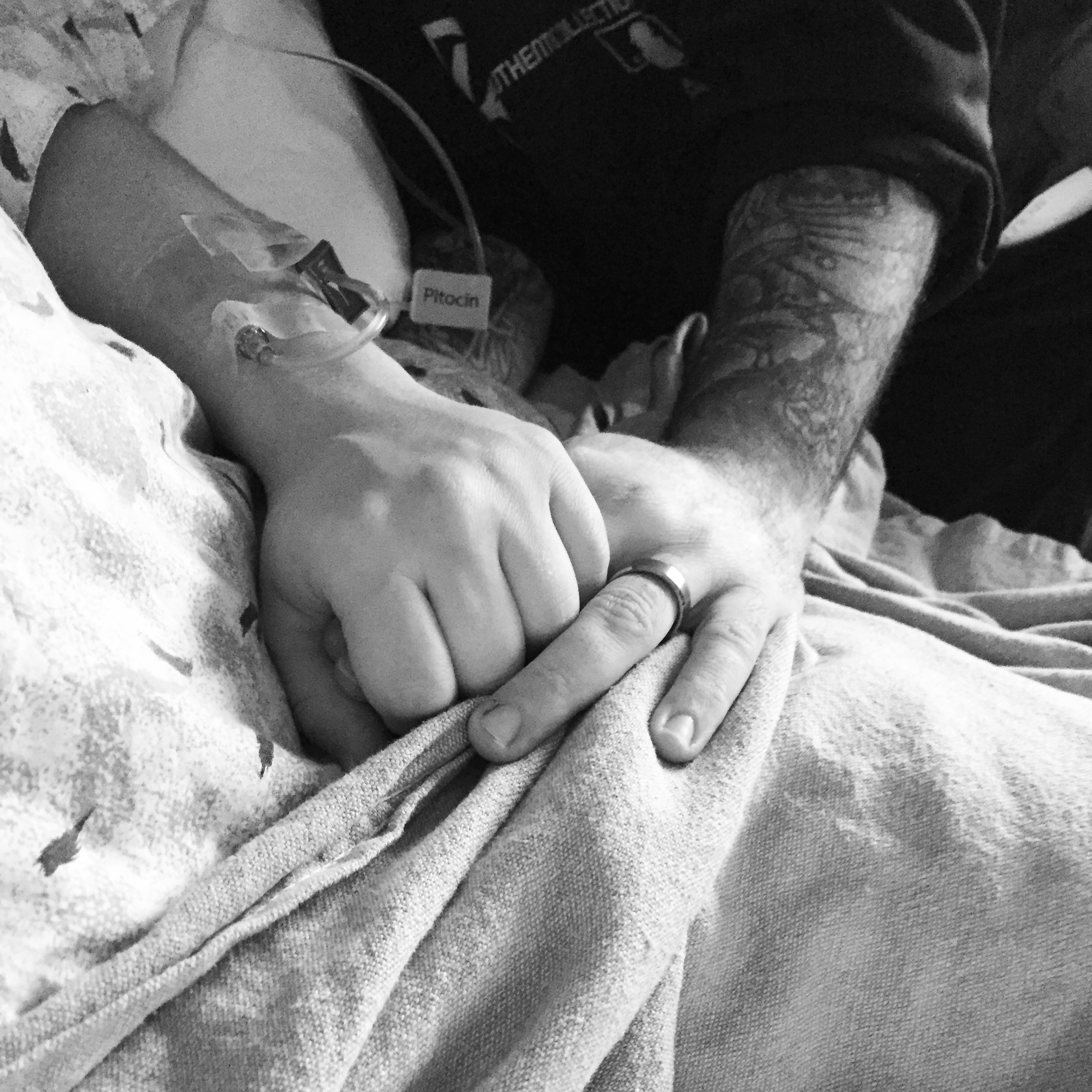 woman; labor; holding hands